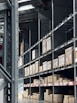 Brightly lit warehouse filled with organized shelves of various construction supplies.