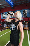 Athlete drinking a protein shake after workout in a gym setting