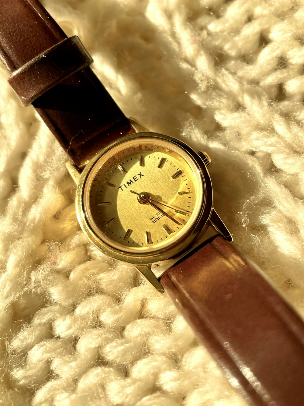 a close up of a watch on a blanket