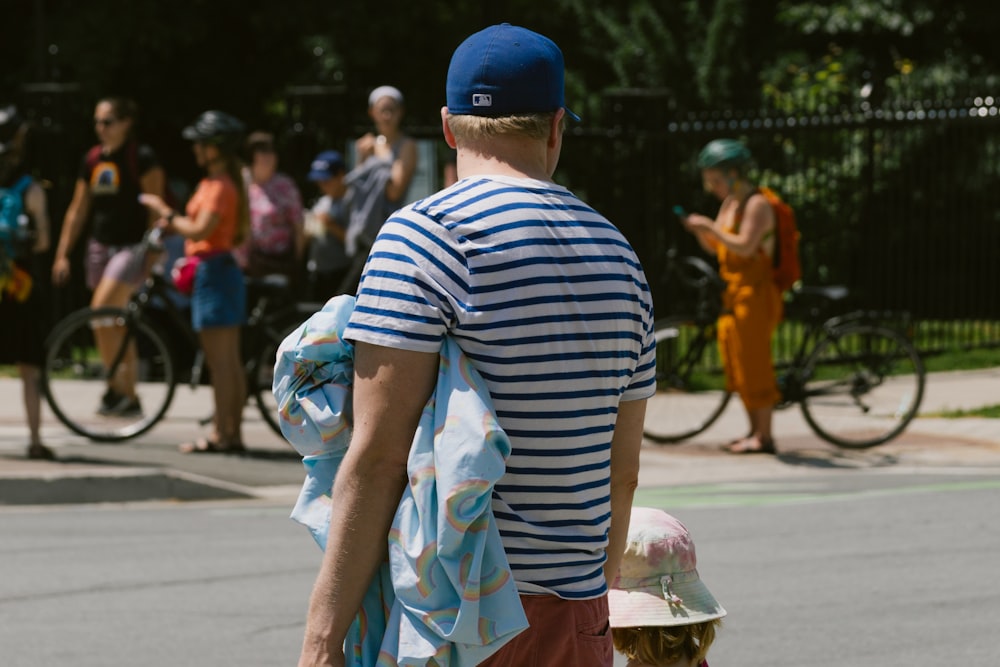 a man in a blue and white striped shirt and hat