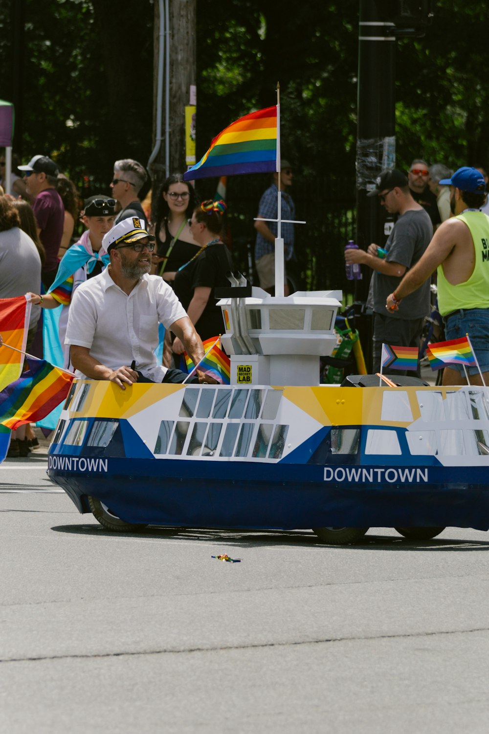 a man riding on the back of a boat in a parade