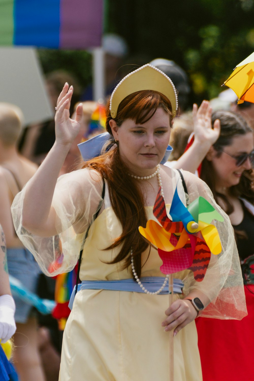 a woman in a yellow dress holding an umbrella