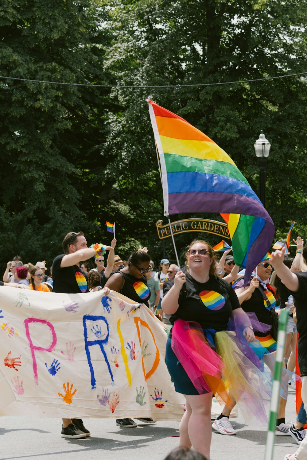 a group of people holding a rainbow flag