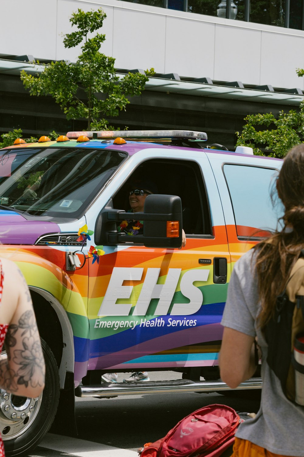 a truck with a rainbow stripe painted on the side of it