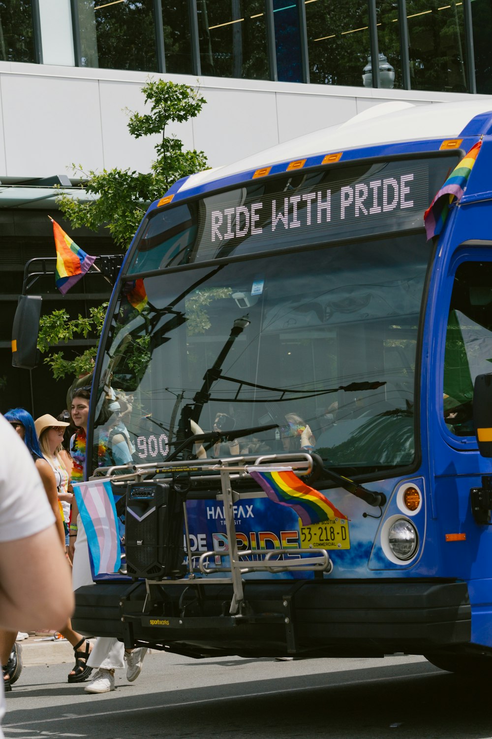 a blue and white bus driving down a street