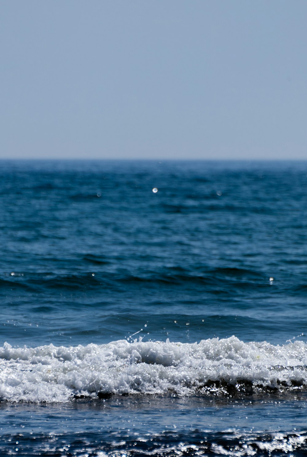 a man riding a wave on top of a surfboard