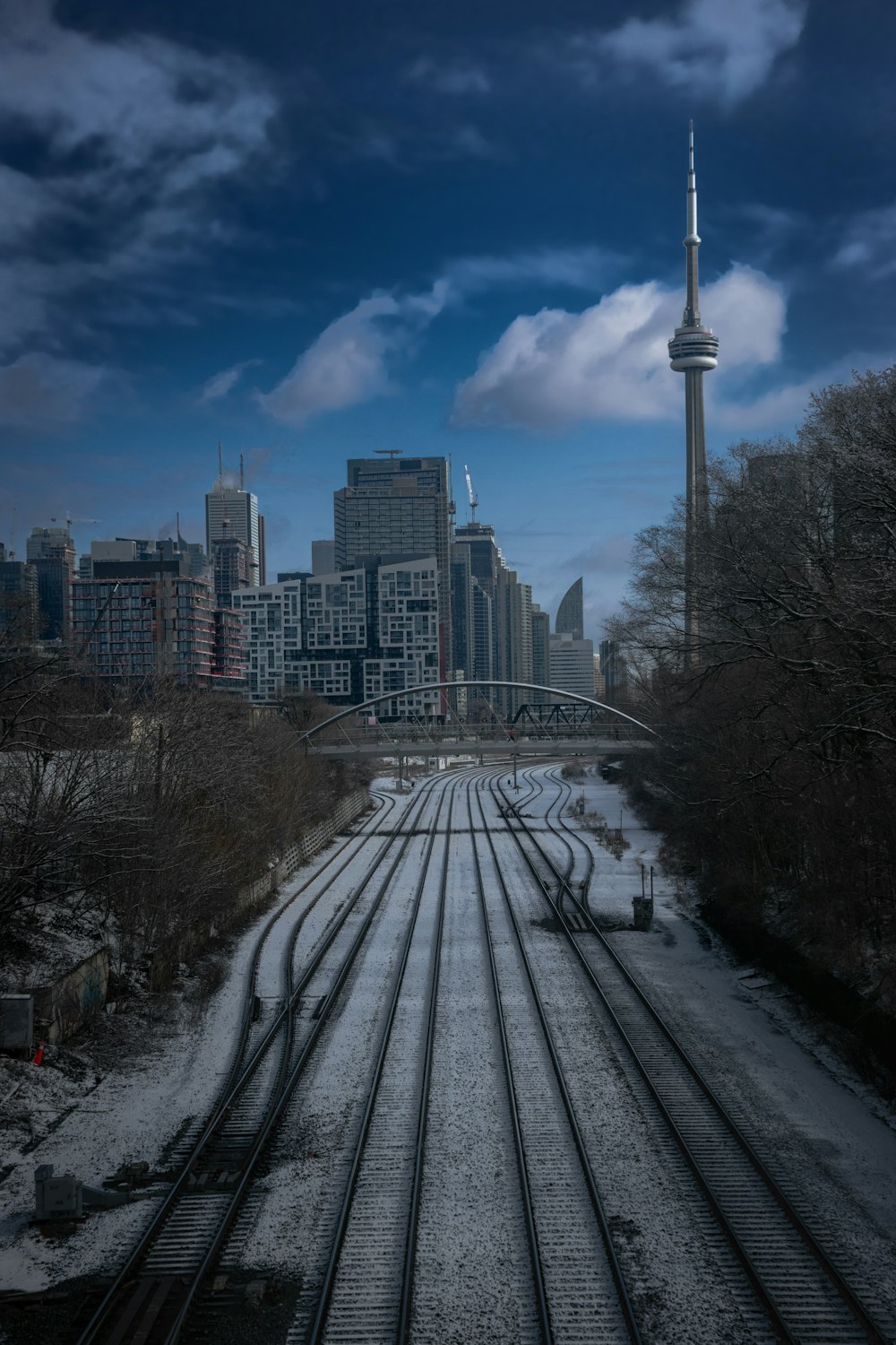 a train track with a city in the background