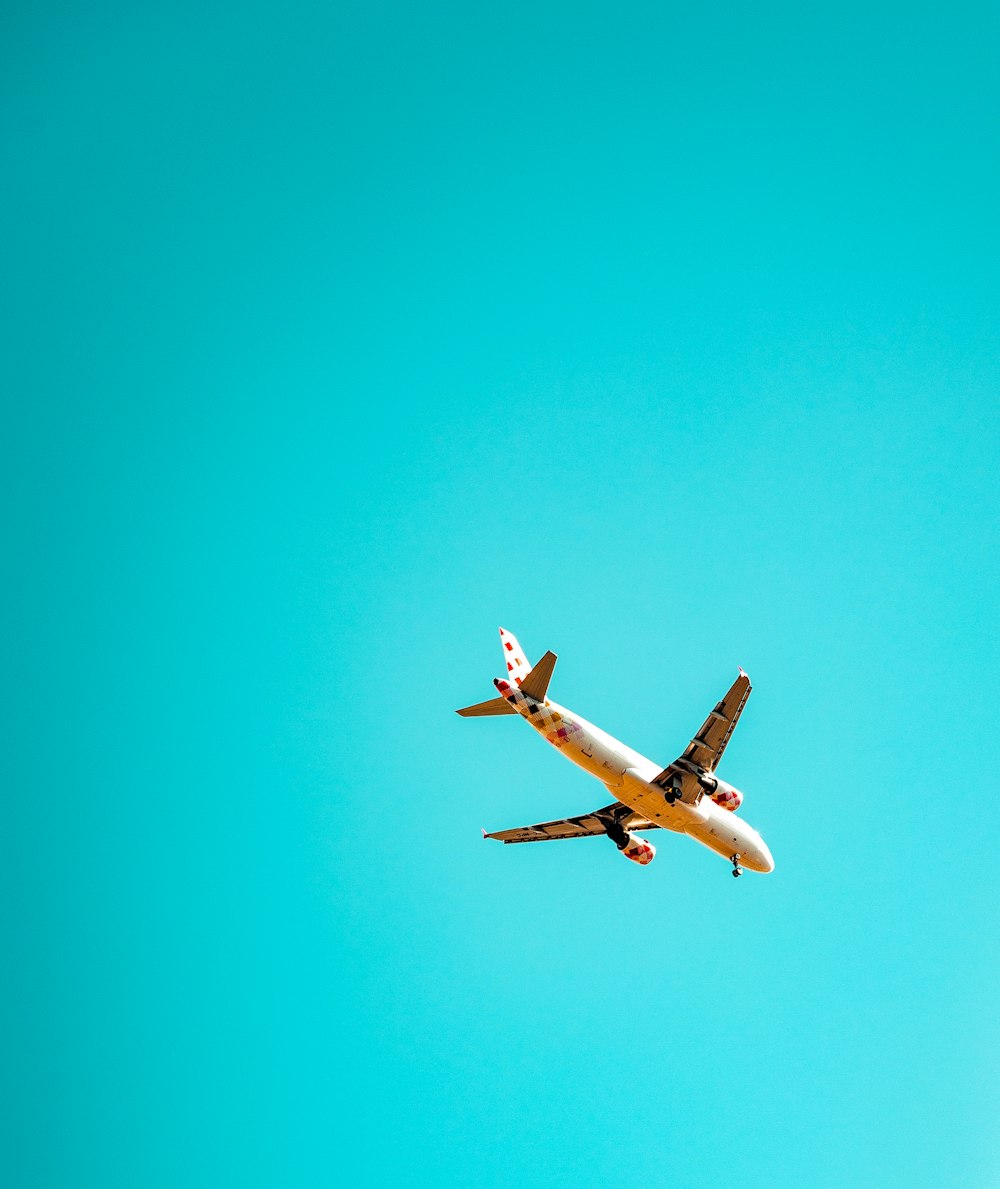 an airplane is flying in the blue sky