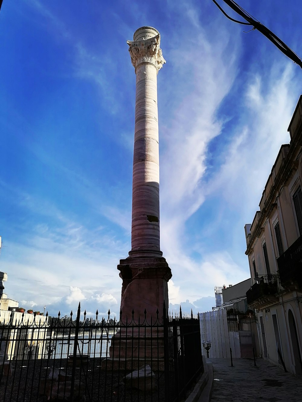 a tall white pillar sitting in the middle of a street