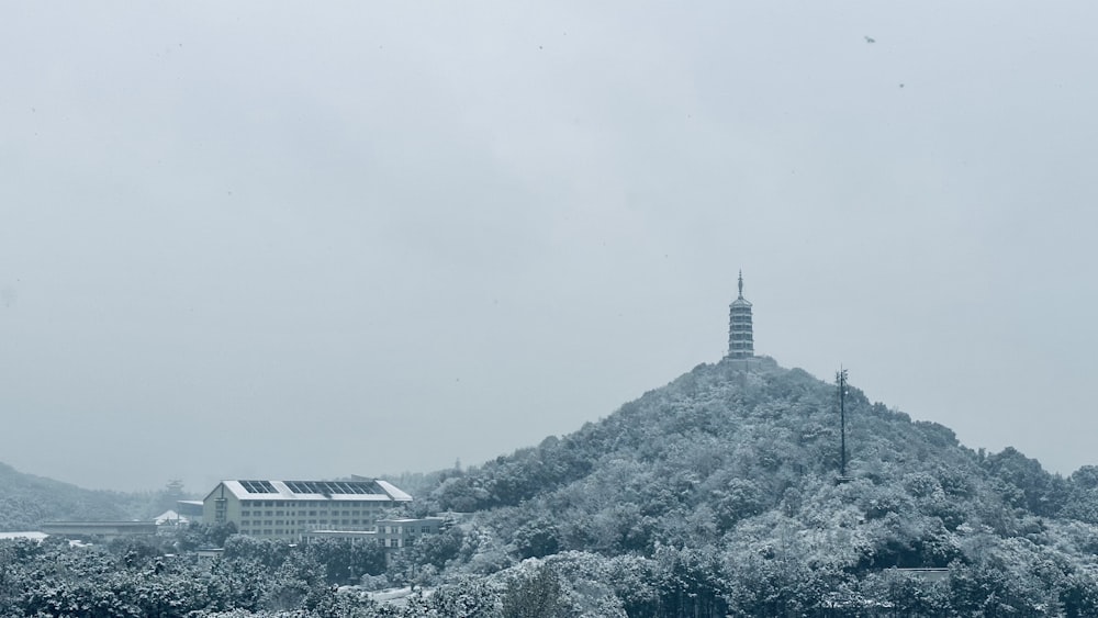 a snow covered mountain with a clock tower in the distance
