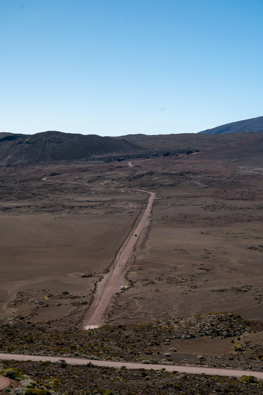 a dirt road in the middle of a desert