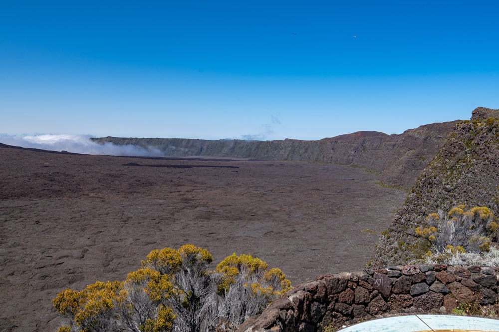 a view of a barren landscape with mountains in the distance