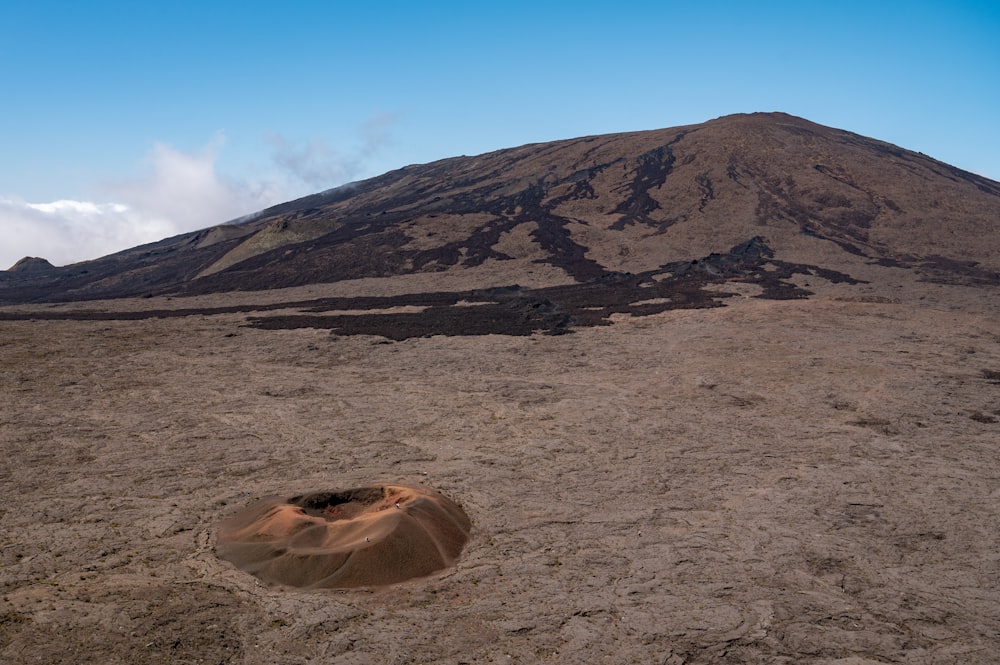 a large mountain with a small hole in the middle of it