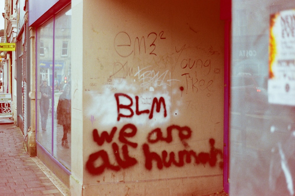 graffiti on the side of a building that says blm we are all human