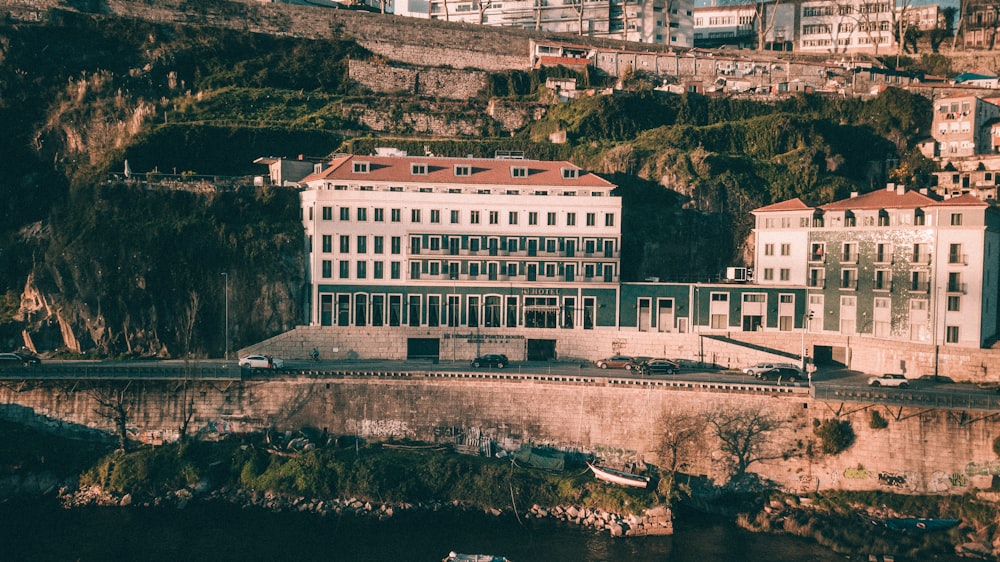a large white building sitting on the side of a cliff