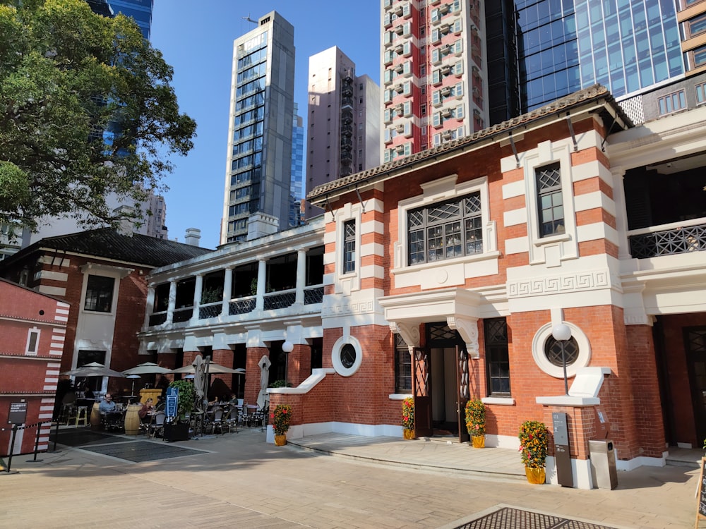 a red and white building with tall buildings in the background