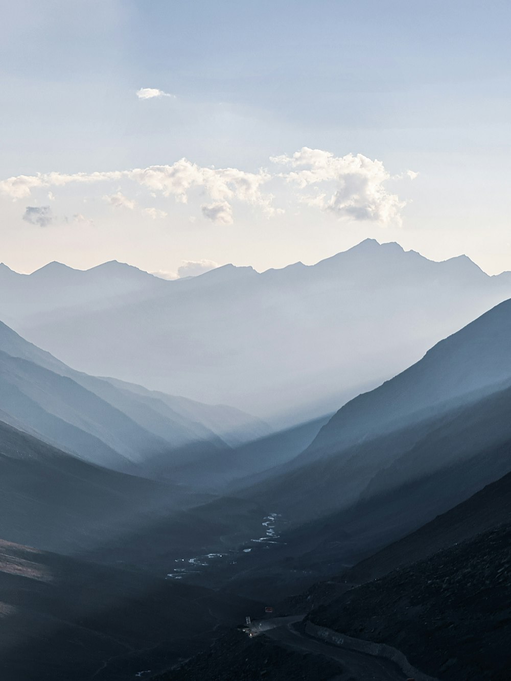 a view of a valley with mountains in the background