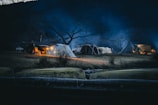 Night scene of glowing tents under a starry sky at the multi-adventure glamping site