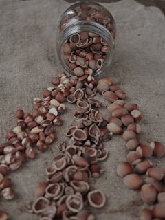 a jar filled with nuts sitting on top of a table