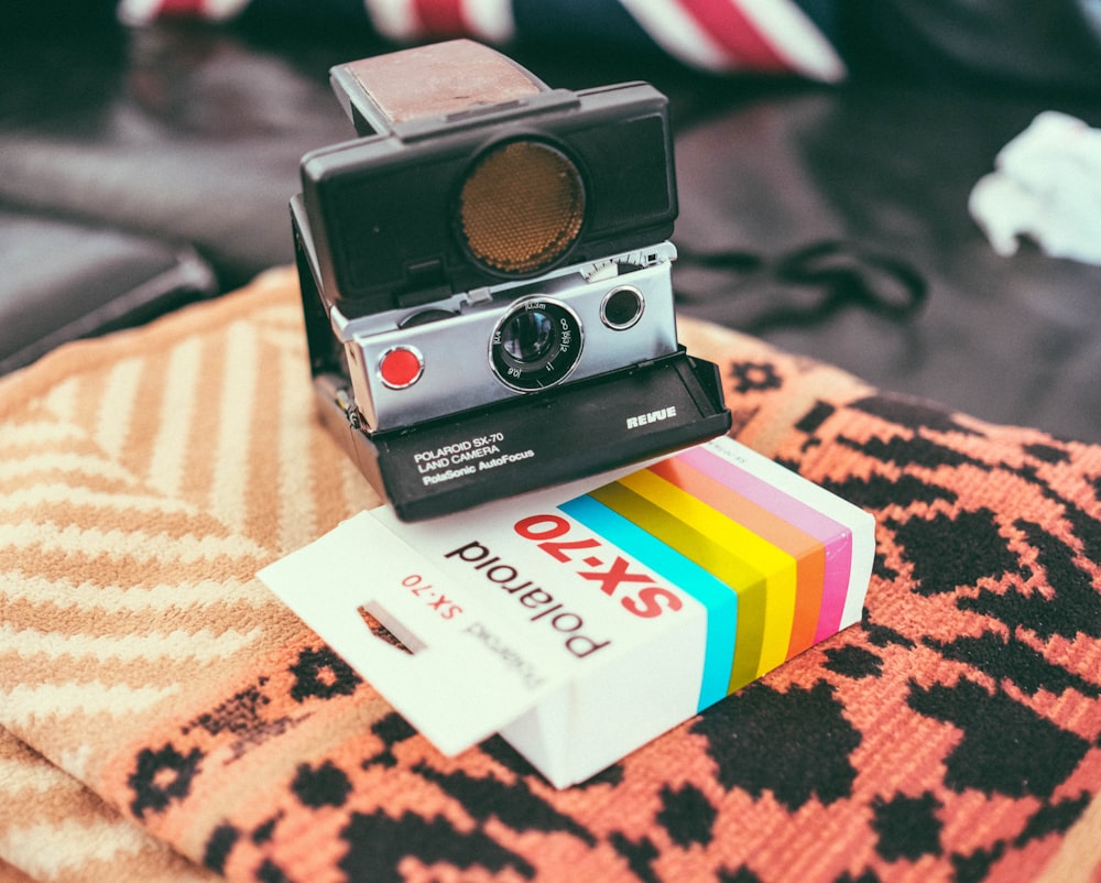 a polaroid camera sitting on top of a pillow