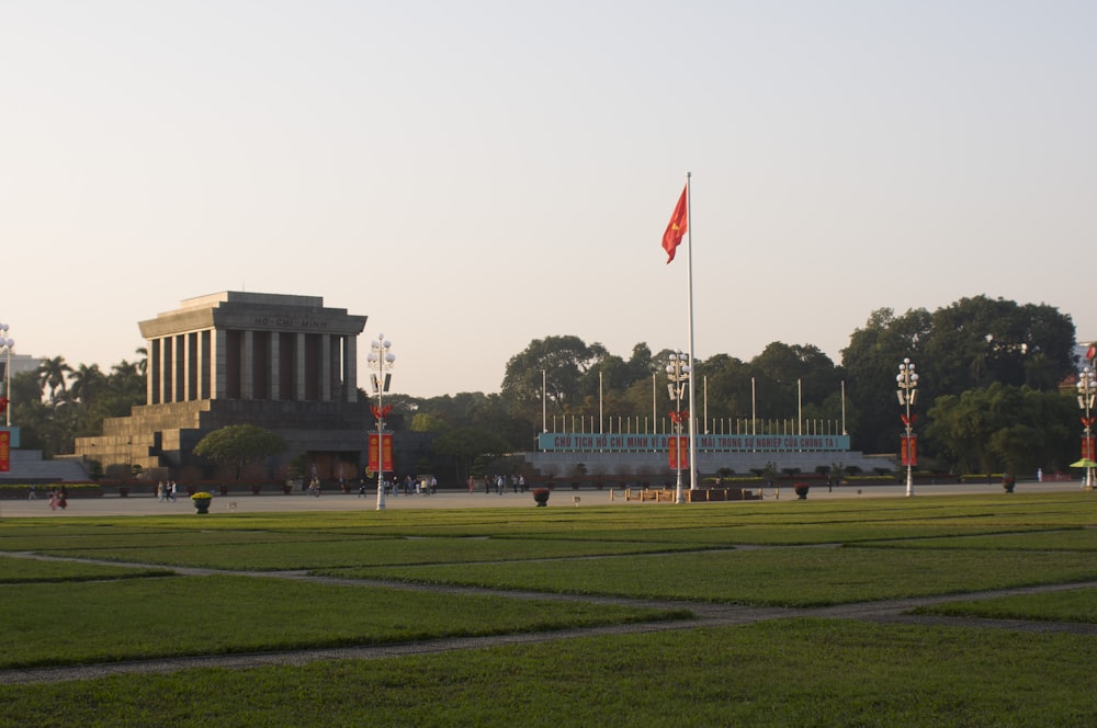 a large grassy field with a building in the background