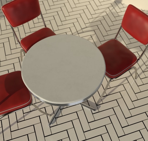 a round table with four red chairs around it