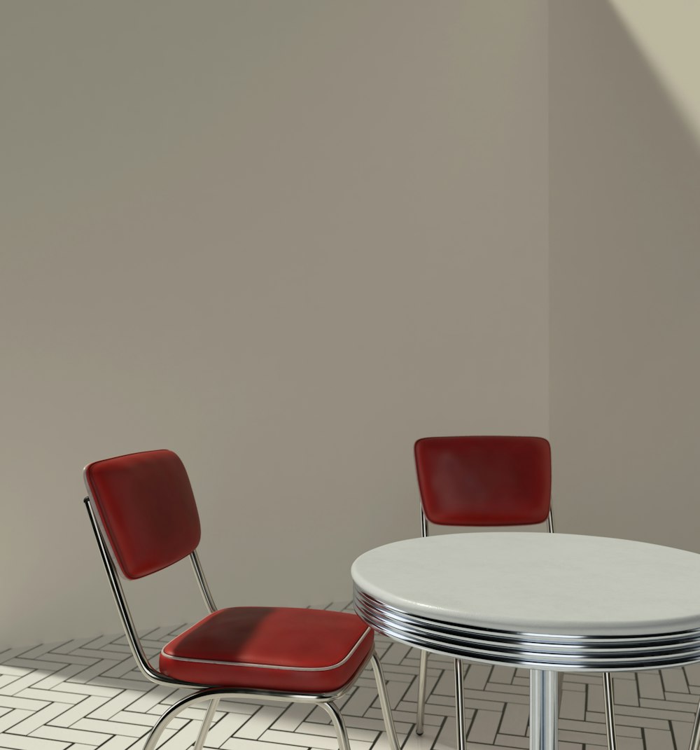 a white table with two red chairs next to it