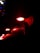 Several red LED lights are illuminated against a dark background, positioned closely along a horizontal surface, creating a dramatic contrast with the dark surroundings.