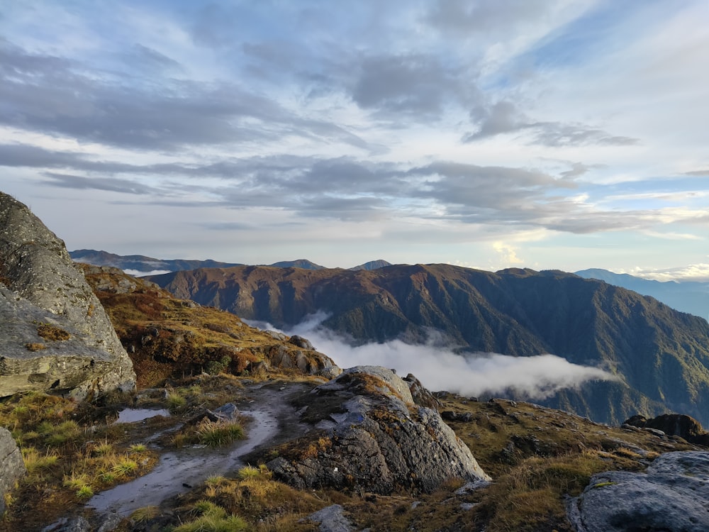 a view of a mountain range with clouds in the sky