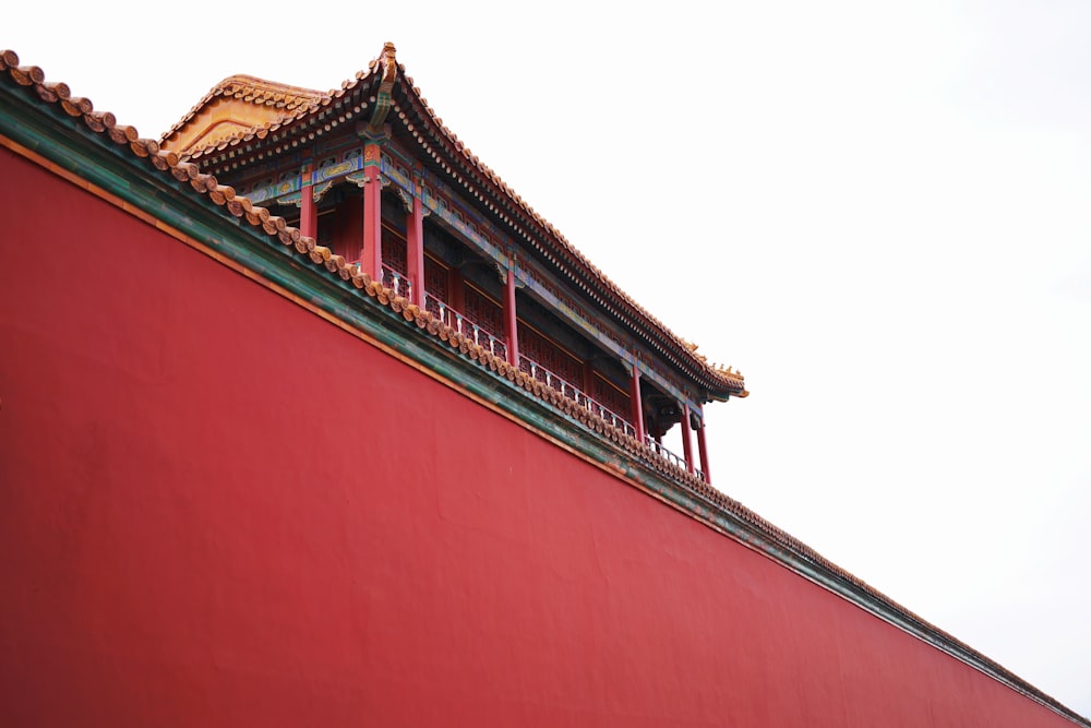 a tall red building with a clock on top of it