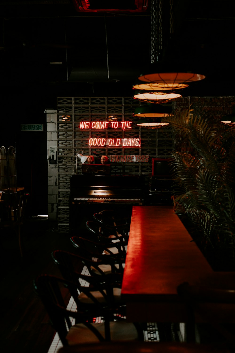 a long table with a neon sign above it