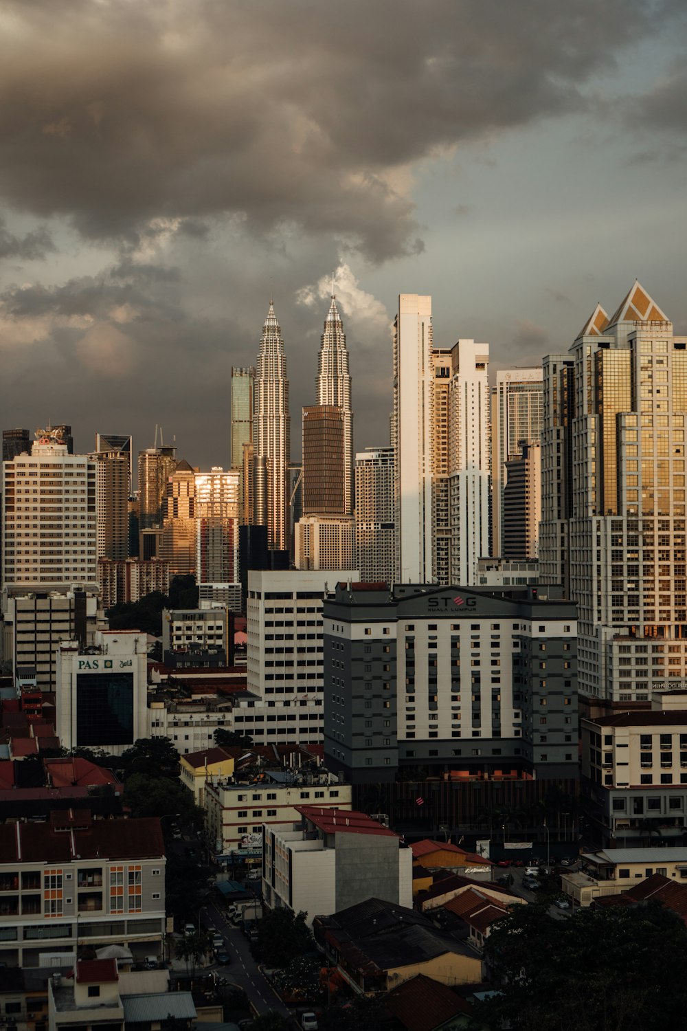 a view of a city with tall buildings under a cloudy sky