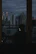 Businessman in sleek office overlooking a city skyline at dusk, deep in thought.