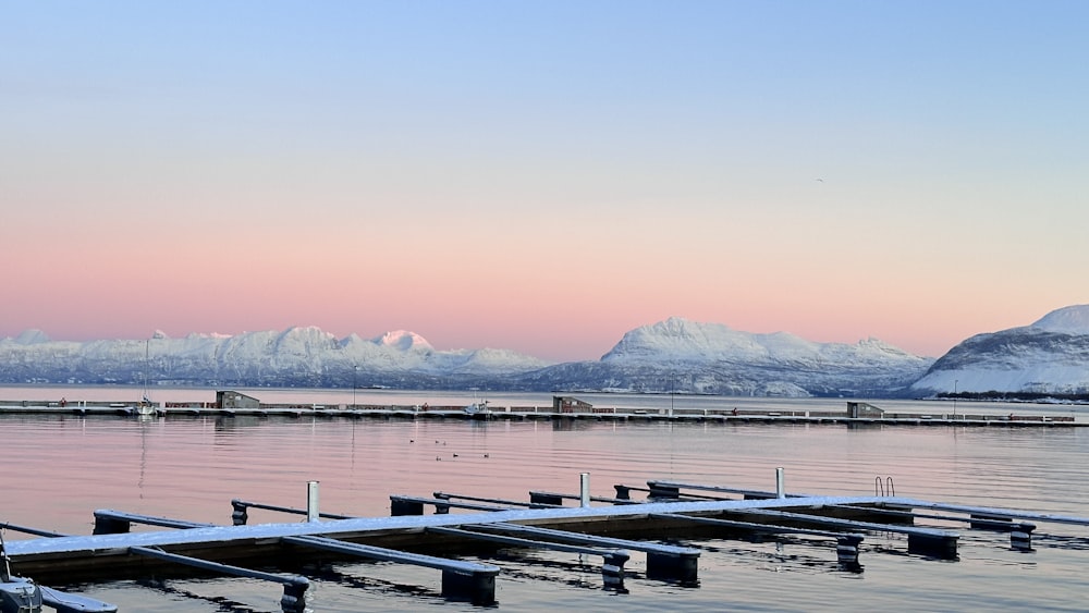 a large body of water with snow covered mountains in the background