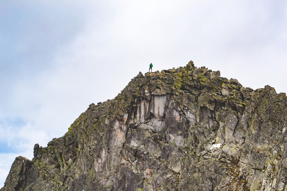 a person standing on top of a large mountain