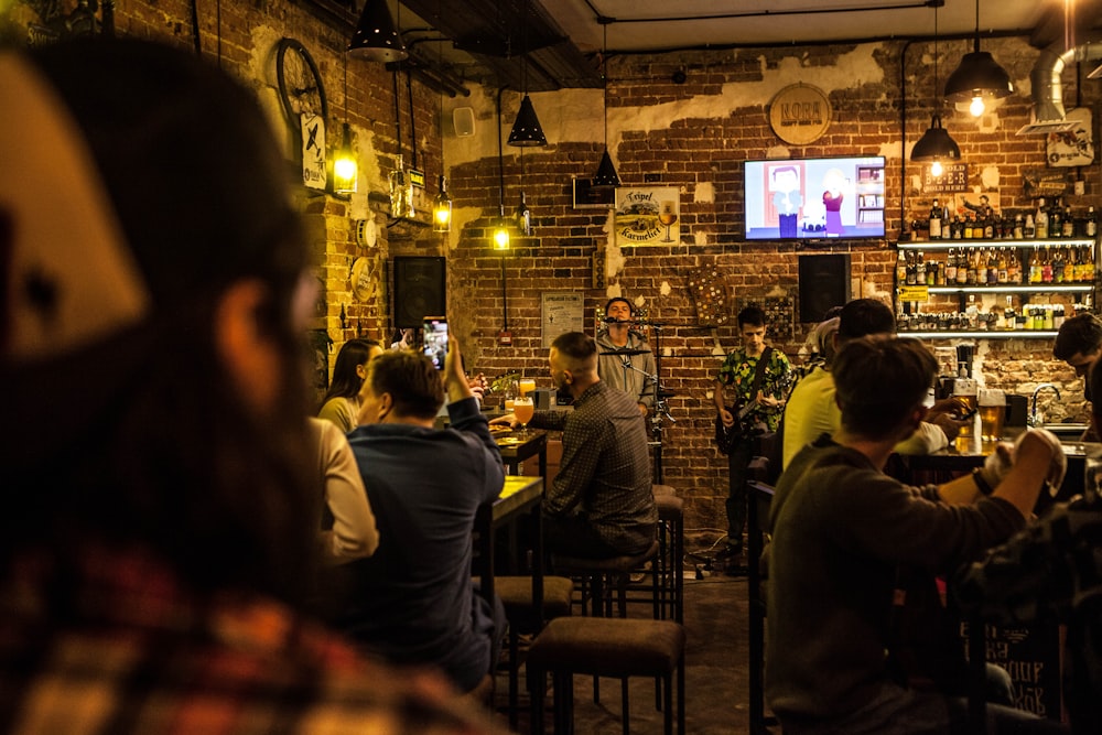 a group of people sitting around a bar