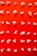 Popcorn is neatly arranged in a grid pattern on a bright red background, creating a visually striking contrast. Each kernel is distinct, with different shapes and sizes, highlighting the irregular nature of popcorn.