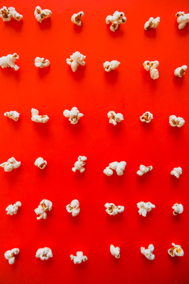 a bunch of popcorn sitting on top of a red table