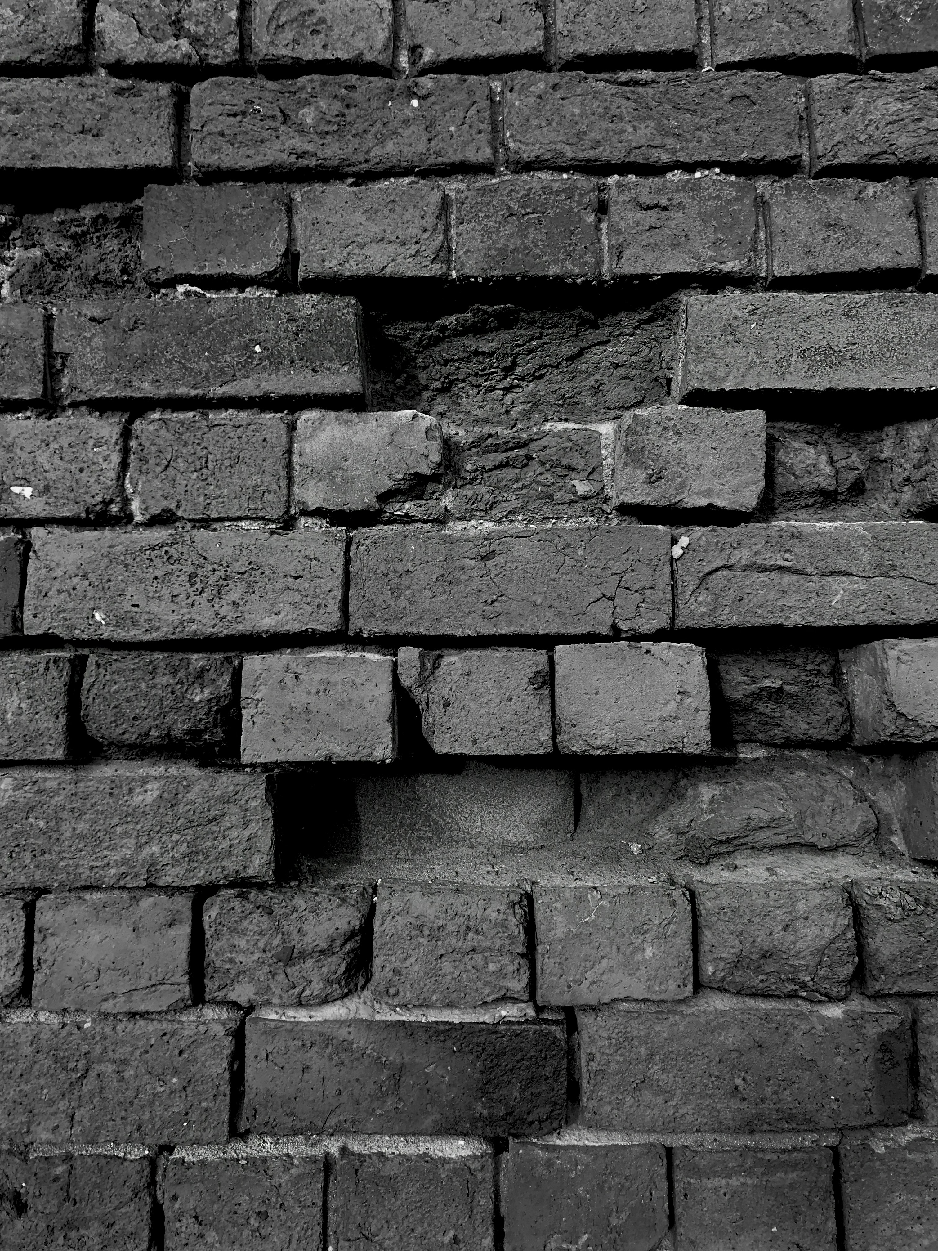 a black and white photo of a brick wall
