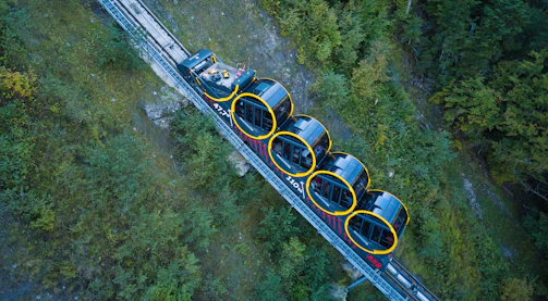 An elevated fixed-guideway connector weaving through forested mountains toward Gatlinburg.