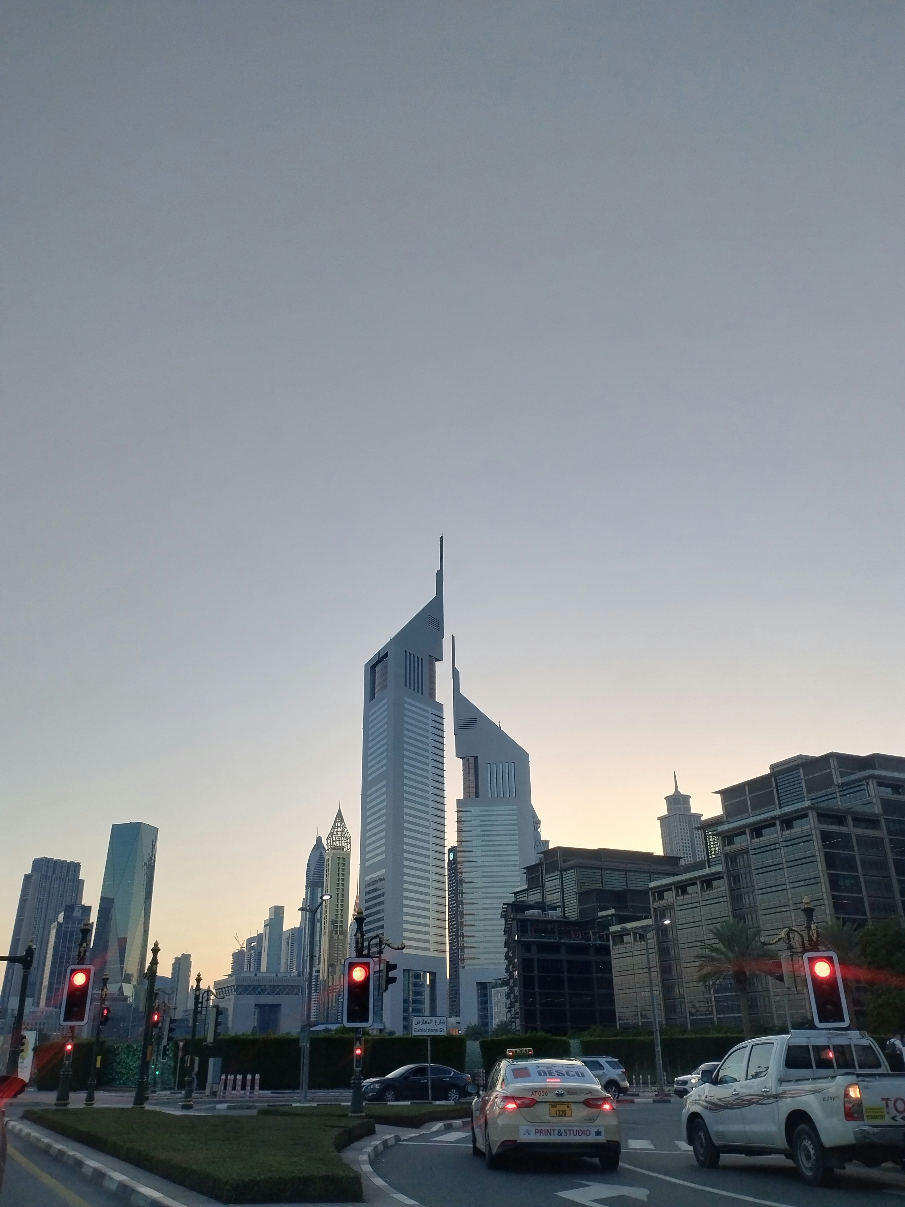 A city street filled with traffic next to tall buildings photo – Free ...