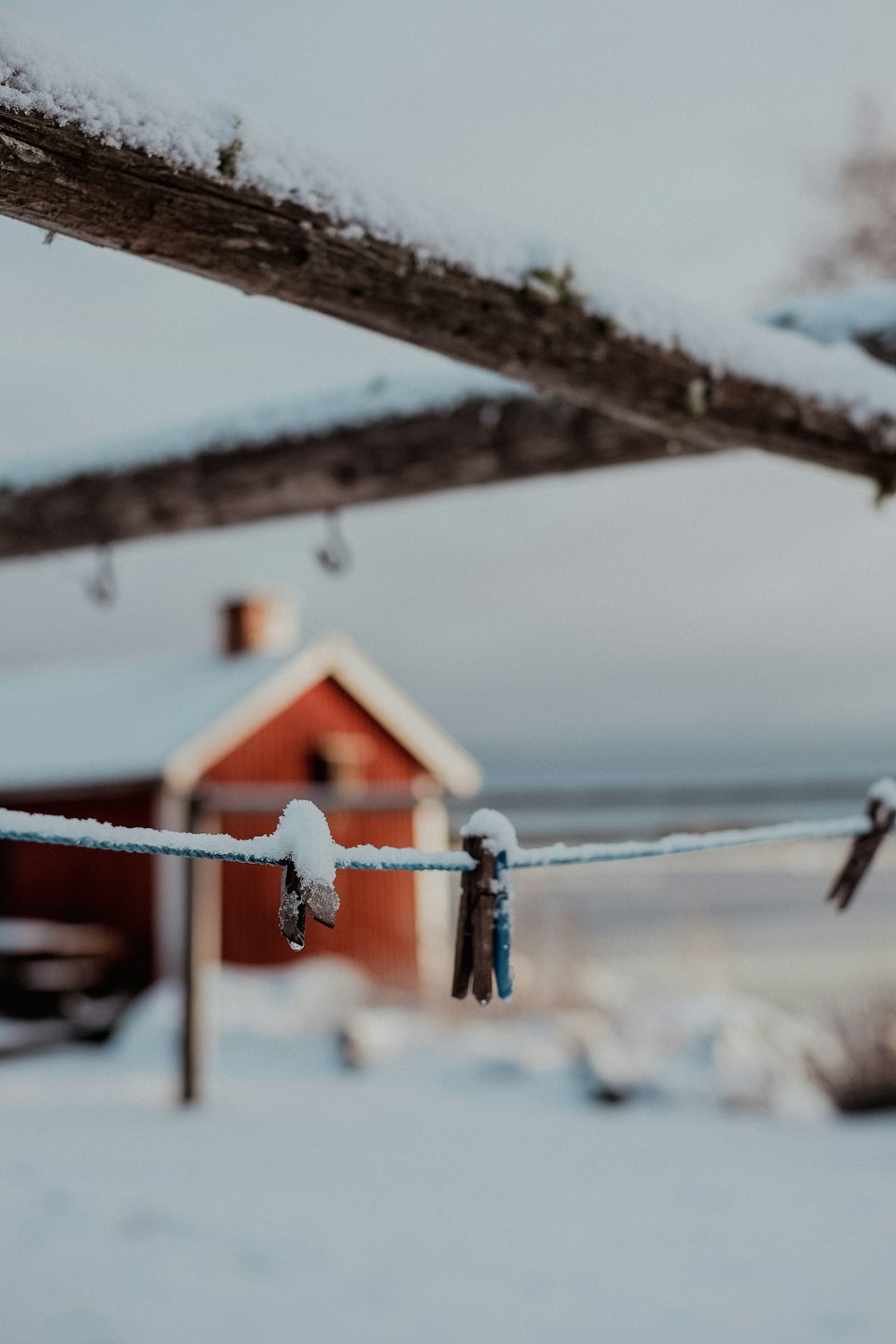 a snow covered field with a house in the background