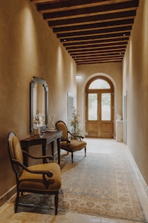 A hallway styled with framed art and a rustic wooden console table.
