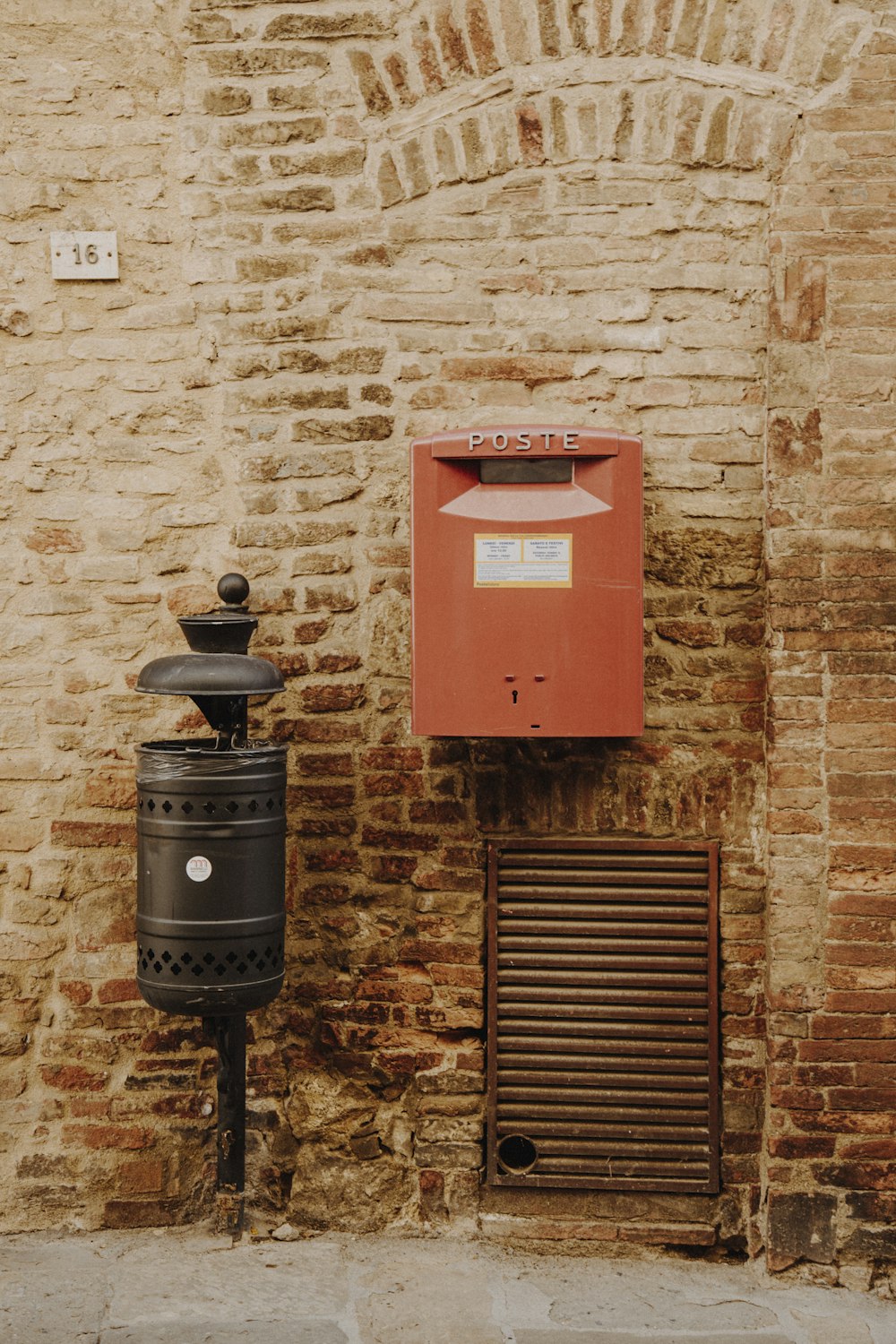 a red mailbox next to a black mailbox