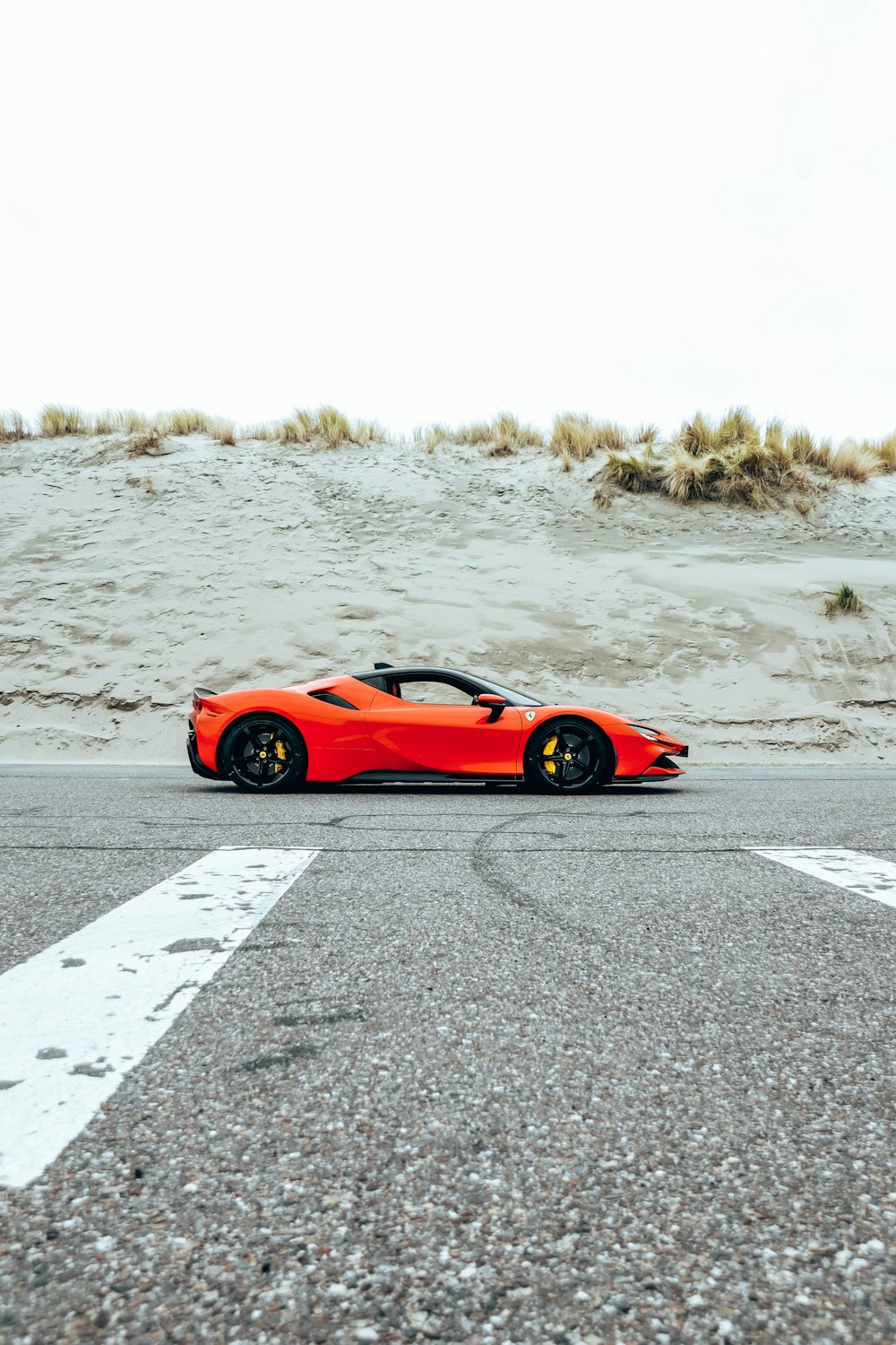 a red sports car parked on the side of the road