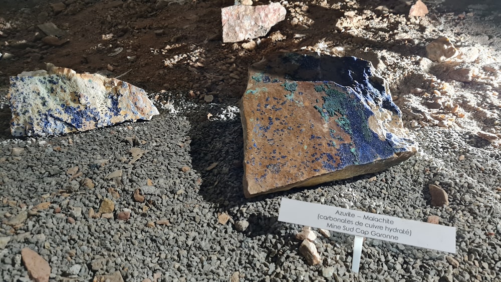 some rocks and a sign on the ground