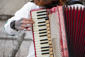 Musician playing a diatonic accordion adorned with a custom ar design sticker.