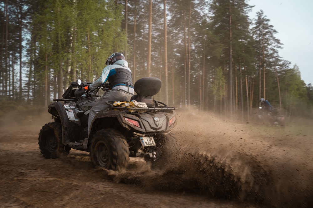 a person riding an atv on a dirt road