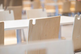 a row of wooden chairs sitting next to each other