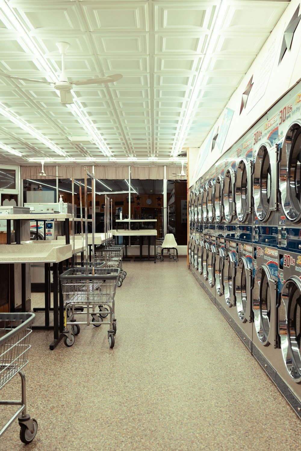 a row of washing machines in a laundry room